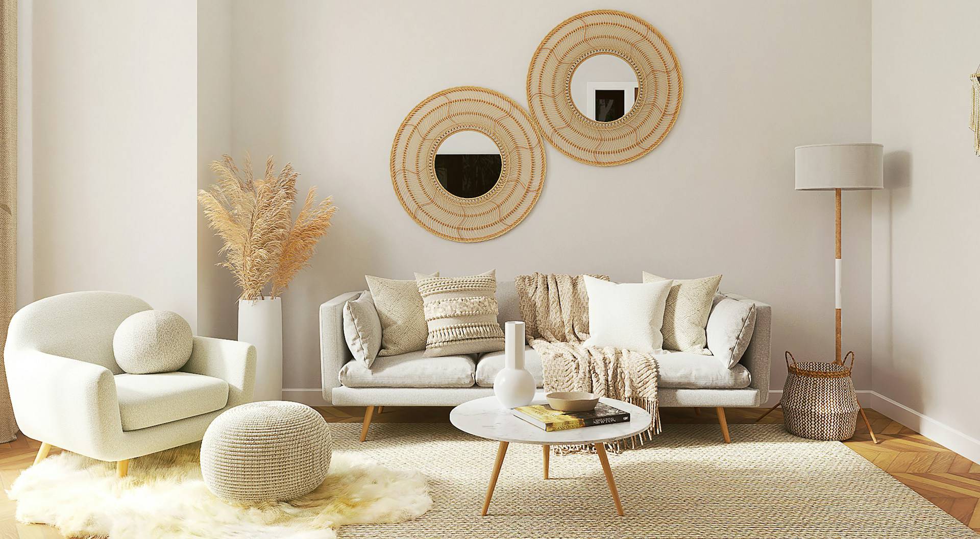 Cozy neutral-toned living room with a modern sofa, round coffee table, accent chair, woven decor, and layered pillows and throws.
